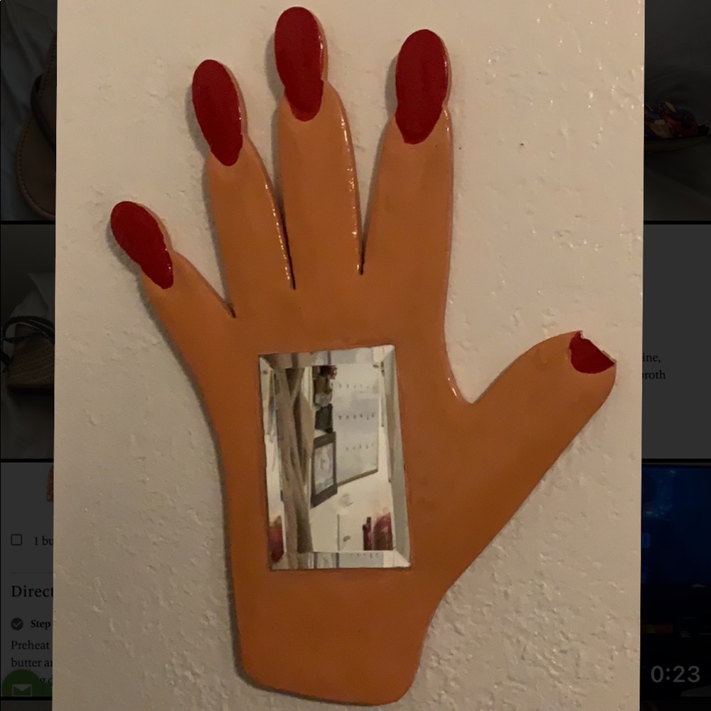 Hand shaped mirror